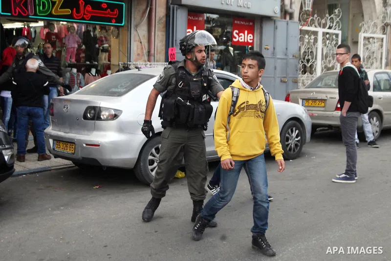 Israeli policemen arrest a Palestinian during clashes in East Jerusalem neighborhood Ras al-Amud, on March 01, 2014. Photo by Saeed Qaq
