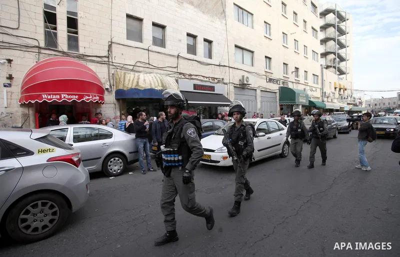 Israeli policemen arrest a Palestinian during clashes in East Jerusalem neighborhood Ras al-Amud, on March 01, 2014. Photo by Saeed Qaq