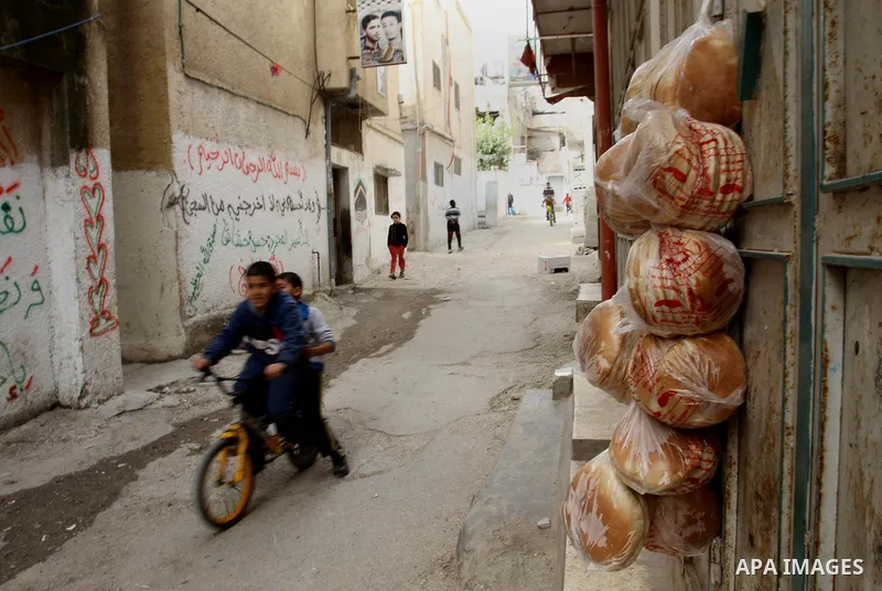 Palestinian children play outside their family's house at Balata refugee camp, near the West Bank City of Nablus, March 04, 2014. Photo by Nedal Eshtayah