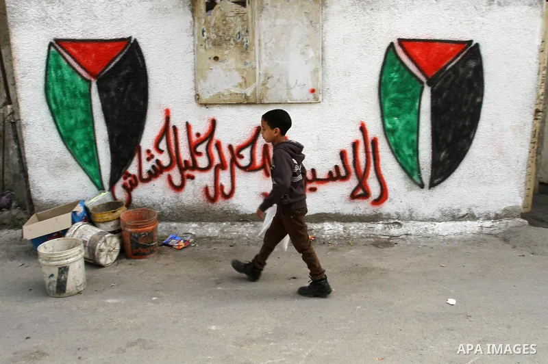 A Palestinian boy plays outside his family's house at Balata refugee camp, near the West Bank City of Nablus, March 04, 2014. Photo by Nedal Eshtayah