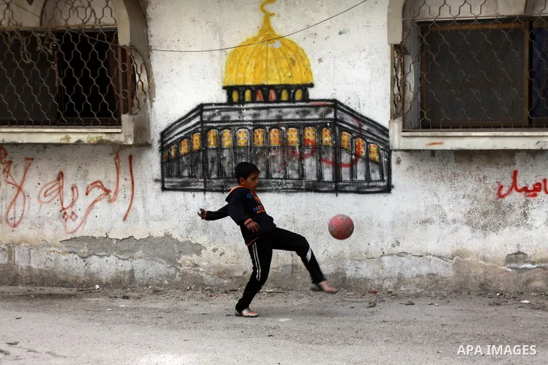 A Palestinian boy plays outside his family's house at Balata refugee camp, near the West Bank City of Nablus, March 04, 2014. Photo by Nedal Eshtayah