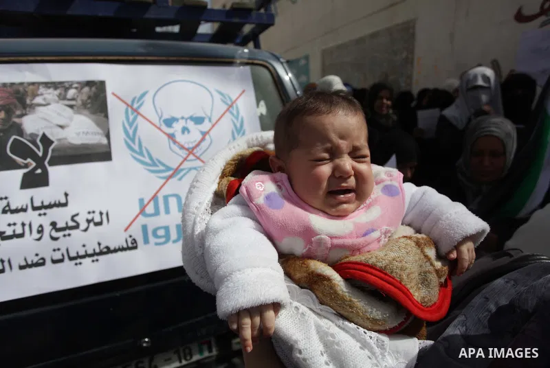 Palestinian women take part in a protest against the decision made by the United Nations Relief and Works Agency (UNRWA) to reduce food aid delivered to the Gaza Strip in front of the UNRWA headquarters in Gaza City on M...