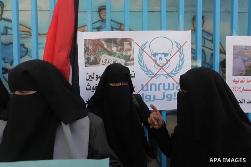 Palestinian women take part in a protest against the decision made by the United Nations Relief and Works Agency (UNRWA) to reduce food aid delivered to the Gaza Strip in front of the UNRWA headquarters in Gaza City on M...