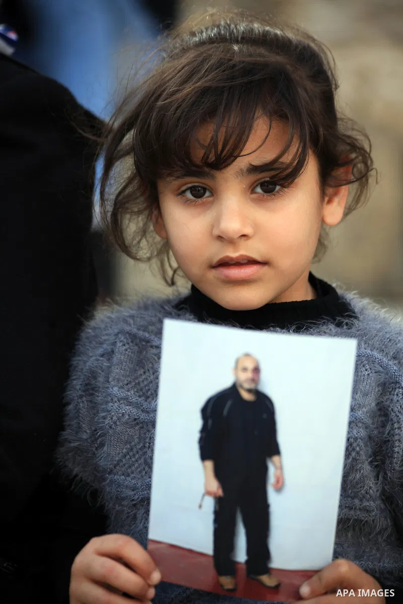 Palestinian protesters hold posters and banners with portraits of Palestinian prisoners in Israeli jail on March 8, 2014 during a demonstration to called for their release at the Damascus Gate in Jerusalem's Old City. Ph...
