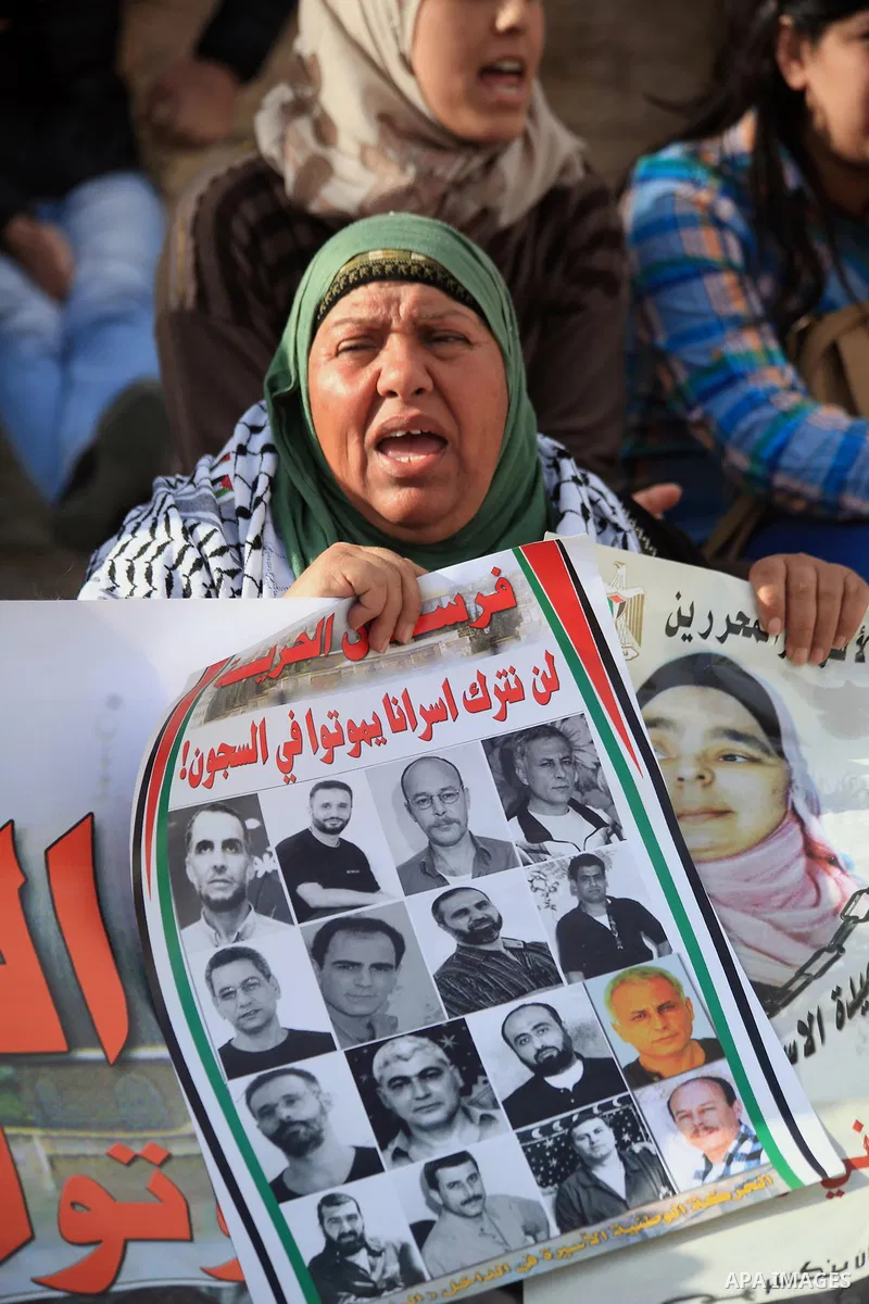 Palestinian protesters hold posters and banners with portraits of Palestinian prisoners in Israeli jail on March 8, 2014 during a demonstration to called for their release at the Damascus Gate in Jerusalem's Old City. Ph...