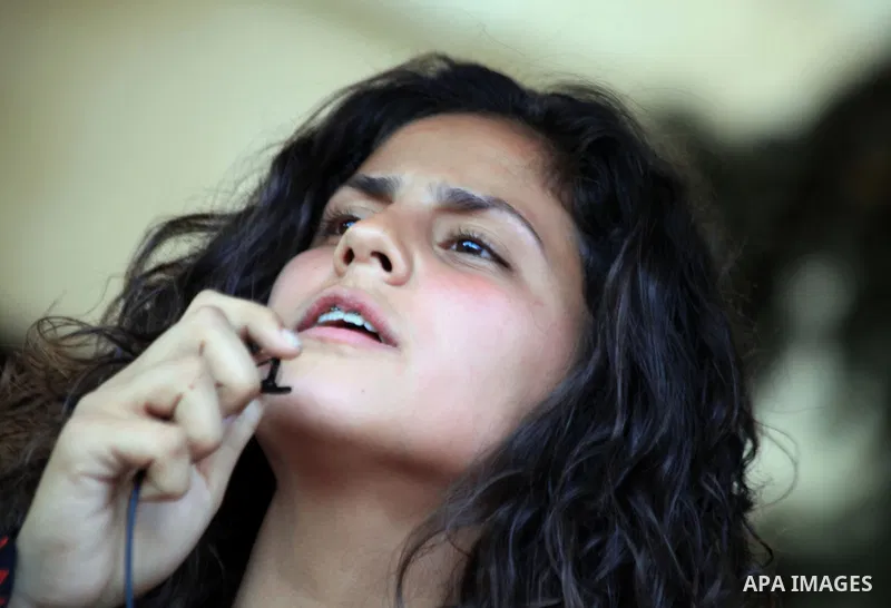 A Palestinian girl participates in the ceremony of the International women's Day in Jerusalem's Old City, on March 8, 2014. On March 8 people around the globe celebrate International Women's Day, which dates back to the...