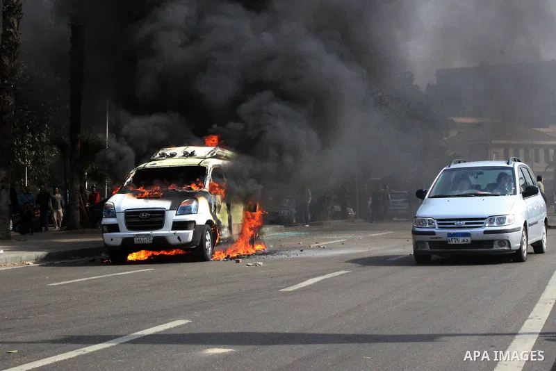 A car belonging to the media burns during a protest by supporters of the Muslim Brotherhood and ousted Egyptian President Mohamed Mursi inside Cairo University, in Cairo, March 9, 2014. Anti-coup students staged on Sunda...