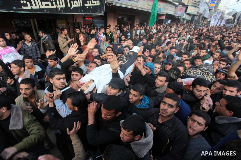 Palestinians carry the bodies of three Islamic Jihad militants, who were killed in an Israeli air strike, during their funeral at a mosque in Khan Younis in the southern Gaza Strip March 11, 2014. An Israeli air strike o...