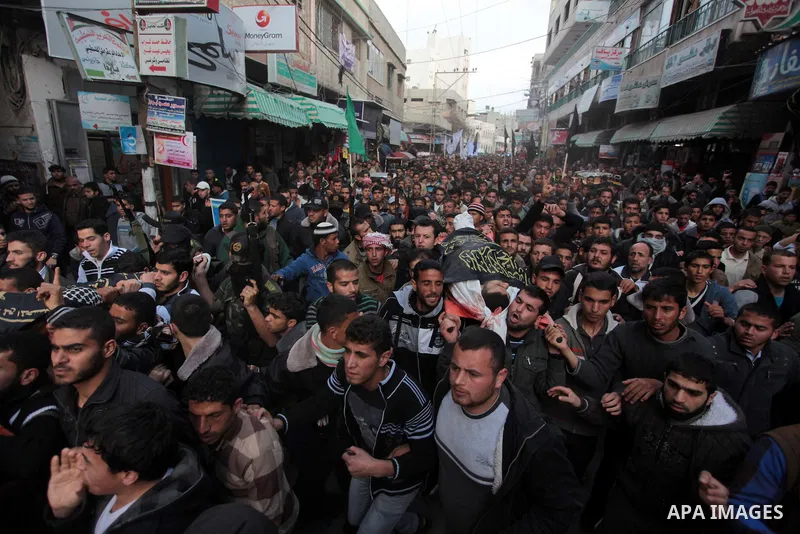 Palestinians carry the bodies of three Islamic Jihad militants, who were killed in an Israeli air strike, during their funeral at a mosque in Khan Younis in the southern Gaza Strip March 11, 2014. An Israeli air strike o...
