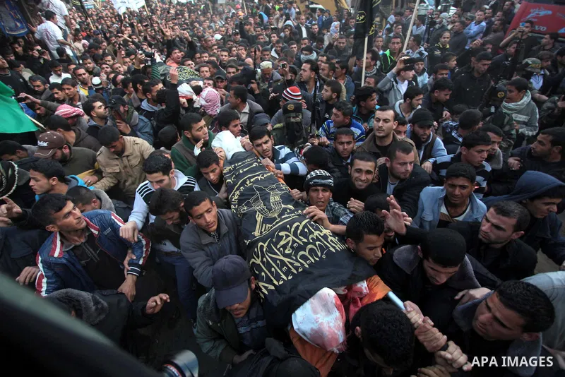 Palestinians carry the bodies of three Islamic Jihad militants, who were killed in an Israeli air strike, during their funeral at a mosque in Khan Younis in the southern Gaza Strip March 11, 2014. An Israeli air strike o...