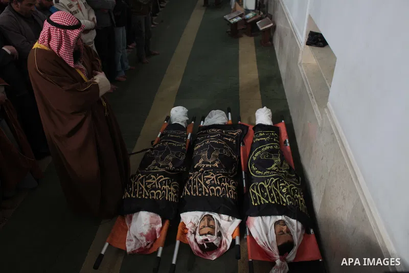 Palestinians pray next to the bodies of three Islamic Jihad militants, who were killed in an Israeli air strike, during their funeral at a mosque in Khan Younis in the southern Gaza Strip March 11, 2014. An Israeli air s...