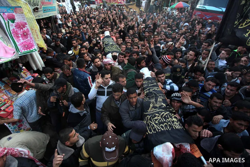 Palestinians carry the bodies of three Islamic Jihad militants, who were killed in an Israeli air strike, during their funeral at a mosque in Khan Younis in the southern Gaza Strip March 11, 2014. An Israeli air strike o...