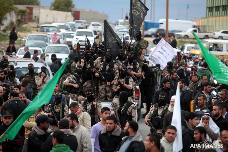Islamic jihad militants take part in the funeral of three comrades, who were killed in an Israeli air strike, in Khan Younis in the southern Gaza Strip March 11, 2014. An Israeli air strike on Tuesday killed three Palest...