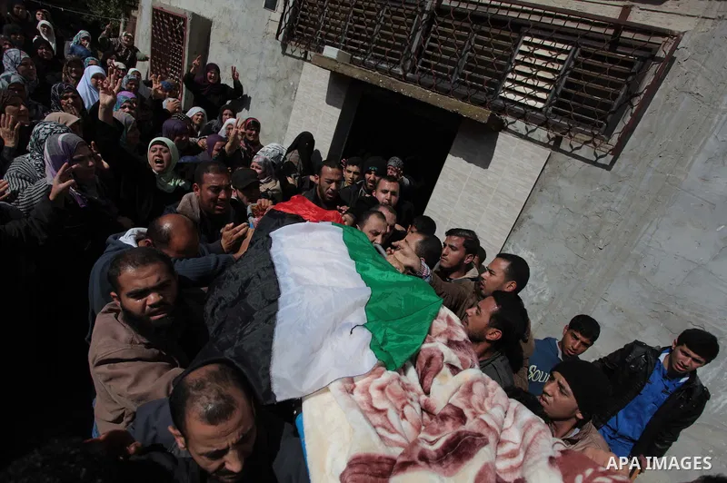 Palestinians carry the body of Kareem Hamad during his funeral at Beit Hanoun on the northern Gaza Strip March 12, 2014. A blast in a second-storey apartment killed Hamad and other two militants belonging to a small Jiha...