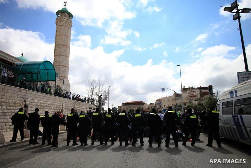 Israeli policemen stand guard as they block Palestinian worshipers from praying in the city's Al-Aqsa mosque, in the Ras Al-Amud neighborhood of East Jerusalem on 14 March 2014. Israel restricted entry for Friday prayers...