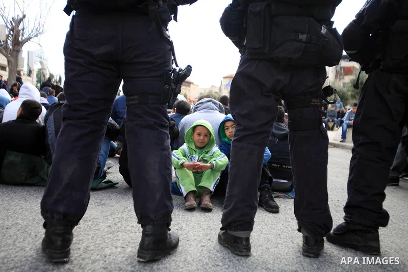 Palestinian Muslims pray outside of the Old City of Jerusalem as Israeli police block them from praying in the city's Al-Aqsa mosque, in the Ras Al-Amud neighborhood of East Jerusalem on 14 March 2014. Israel restricted...