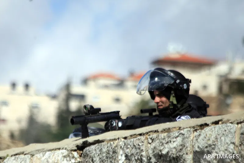 An Israeli policeman stands guard as he blocks Palestinian worshipers from praying in the city's Al-Aqsa mosque, in the Ras Al-Amud neighborhood of East Jerusalem on 14 March 2014. Israel restricted entry for Friday pray...