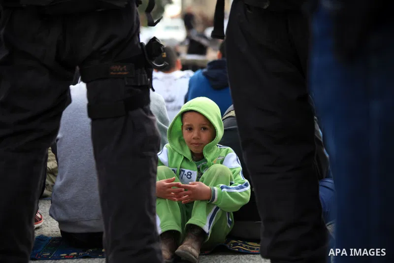 Palestinian Muslims pray outside of the Old City of Jerusalem as Israeli police block them from praying in the city's Al-Aqsa mosque, in the Ras Al-Amud neighborhood of East Jerusalem on 14 March 2014. Israel restricted...