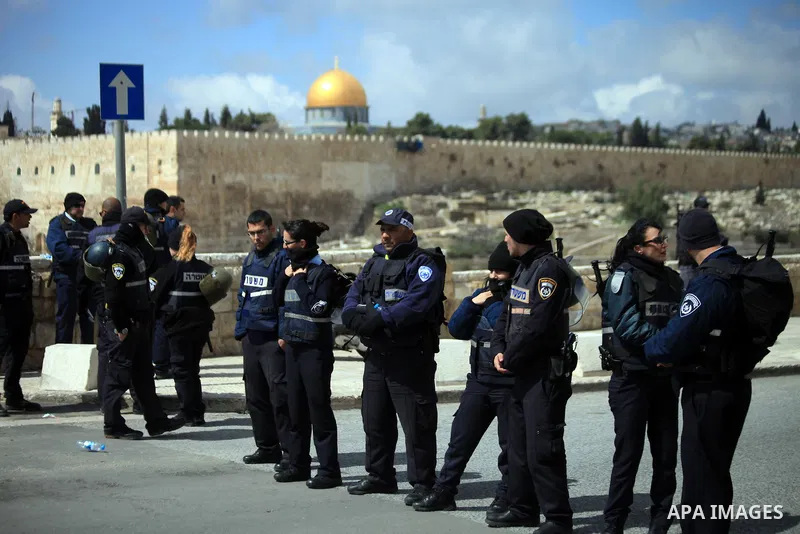 Israeli policemen stand guard as they block Palestinian worshipers from praying in the city's Al-Aqsa mosque, in the Ras Al-Amud neighborhood of East Jerusalem on 14 March 2014. Israel restricted entry for Friday prayers...