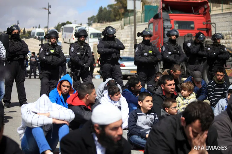 Palestinian Muslims pray outside of the Old City of Jerusalem as Israeli police block them from praying in the city's Al-Aqsa mosque, in the Ras Al-Amud neighborhood of East Jerusalem on 14 March 2014. Israel restricted...