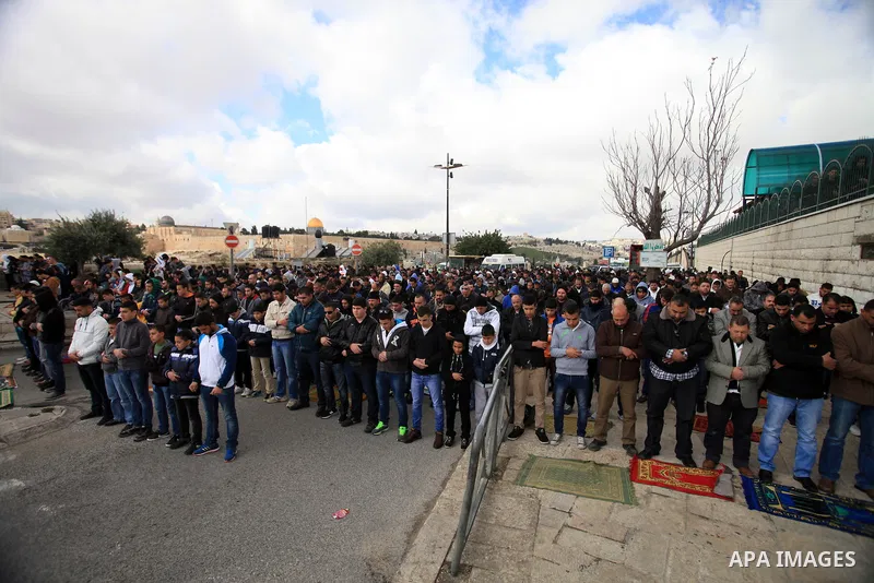 Palestinian Muslims pray outside of the Old City of Jerusalem as Israeli police block them from praying in the city's Al-Aqsa mosque, in the Ras Al-Amud neighborhood of East Jerusalem on 14 March 2014. Israel restricted...