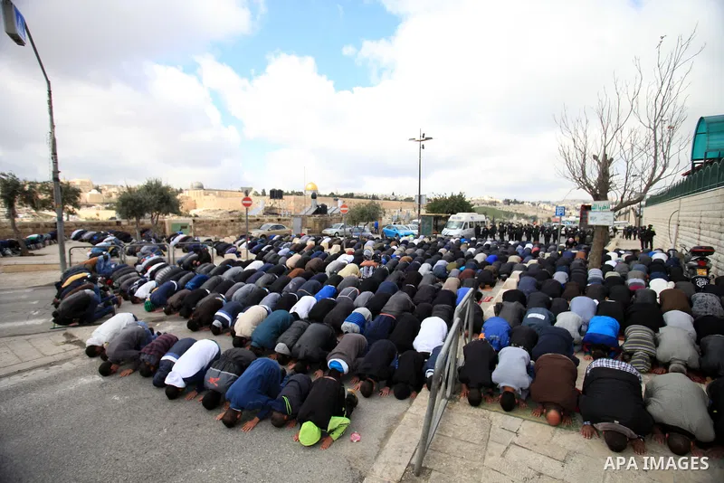 Palestinian Muslims pray outside of the Old City of Jerusalem as Israeli police block them from praying in the city's Al-Aqsa mosque, in the Ras Al-Amud neighborhood of East Jerusalem on 14 March 2014. Israel restricted...