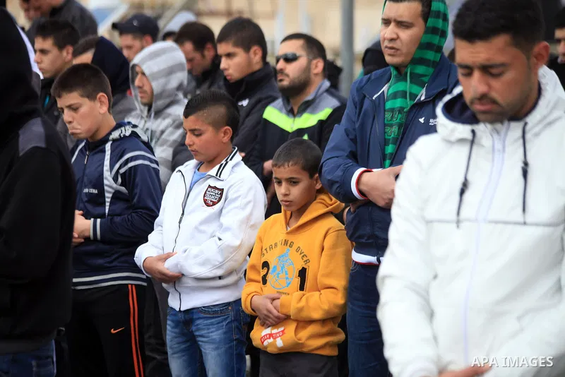 Palestinian Muslims pray outside of the Old City of Jerusalem as Israeli police block them from praying in the city's Al-Aqsa mosque, in the Ras Al-Amud neighborhood of East Jerusalem on 14 March 2014. Israel restricted...