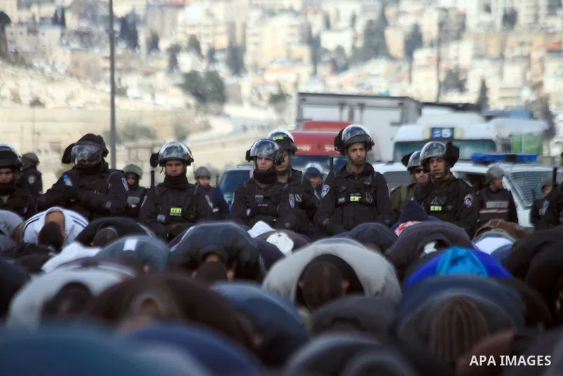 Palestinian Muslims pray outside of the Old City of Jerusalem as Israeli police block them from praying in the city's Al-Aqsa mosque, in the Ras Al-Amud neighborhood of East Jerusalem on 14 March 2014. Israel restricted...