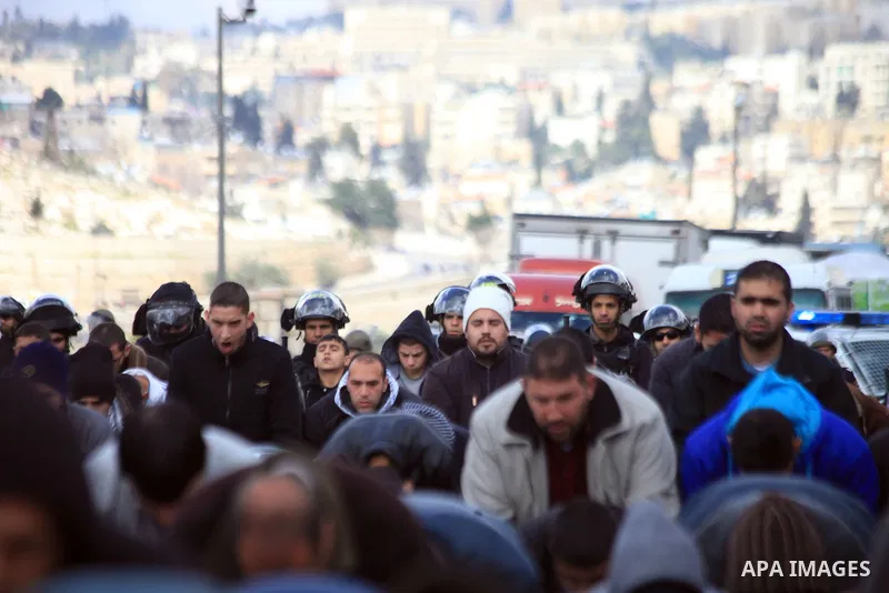 Palestinian Muslims pray outside of the Old City of Jerusalem as Israeli police block them from praying in the city's Al-Aqsa mosque, in the Ras Al-Amud neighborhood of East Jerusalem on 14 March 2014. Israel restricted...