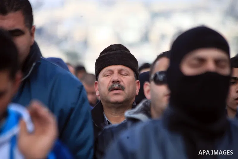 Palestinian Muslims pray outside of the Old City of Jerusalem as Israeli police block them from praying in the city's Al-Aqsa mosque, in the Ras Al-Amud neighborhood of East Jerusalem on 14 March 2014. Israel restricted...