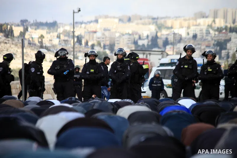 Palestinian Muslims pray outside of the Old City of Jerusalem as Israeli police block them from praying in the city's Al-Aqsa mosque, in the Ras Al-Amud neighborhood of East Jerusalem on 14 March 2014. Israel restricted...