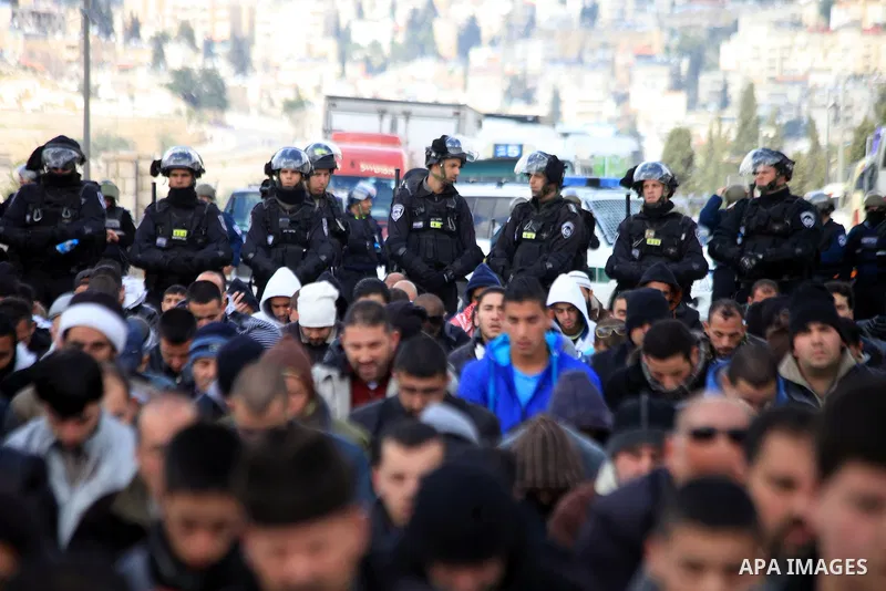 Palestinian Muslims pray outside of the Old City of Jerusalem as Israeli police block them from praying in the city's Al-Aqsa mosque, in the Ras Al-Amud neighborhood of East Jerusalem on 14 March 2014. Israel restricted...