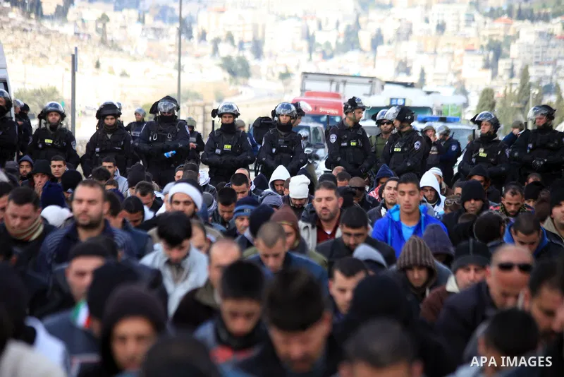 Palestinian Muslims pray outside of the Old City of Jerusalem as Israeli police block them from praying in the city's Al-Aqsa mosque, in the Ras Al-Amud neighborhood of East Jerusalem on 14 March 2014. Israel restricted...
