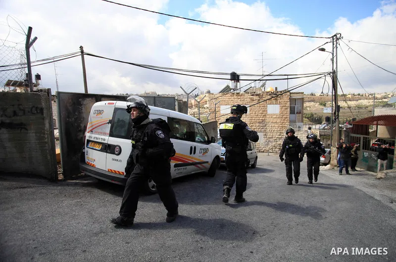 Israeli policemen stand guard as they block Palestinian worshipers from praying in the city's Al-Aqsa mosque, in the Ras Al-Amud neighborhood of East Jerusalem on 14 March 2014. Israel restricted entry for Friday prayers...