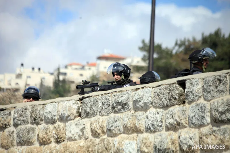 Israeli policemen stand guard as they block Palestinian worshipers from praying in the city's Al-Aqsa mosque, in the Ras Al-Amud neighborhood of East Jerusalem on 14 March 2014. Israel restricted entry for Friday prayers...
