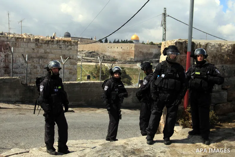 Israeli policemen stand guard as they block Palestinian worshipers from praying in the city's Al-Aqsa mosque, in the Ras Al-Amud neighborhood of East Jerusalem on 14 March 2014. Israel restricted entry for Friday prayers...