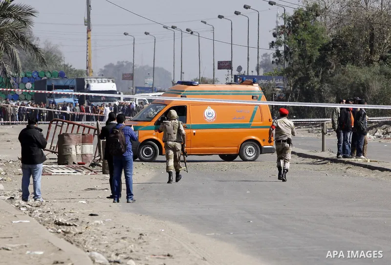 Egyptian soldiers and officials inspect the sight where gunmen killed six soldiers at a Cairo checkpoint on March 15, 2014 in an attack the military blamed on the Muslim Brotherhood movement of deposed president Mohamed...