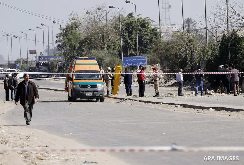 Egyptian soldiers and officials inspect the sight where gunmen killed six soldiers at a Cairo checkpoint on March 15, 2014 in an attack the military blamed on the Muslim Brotherhood movement of deposed president Mohamed...