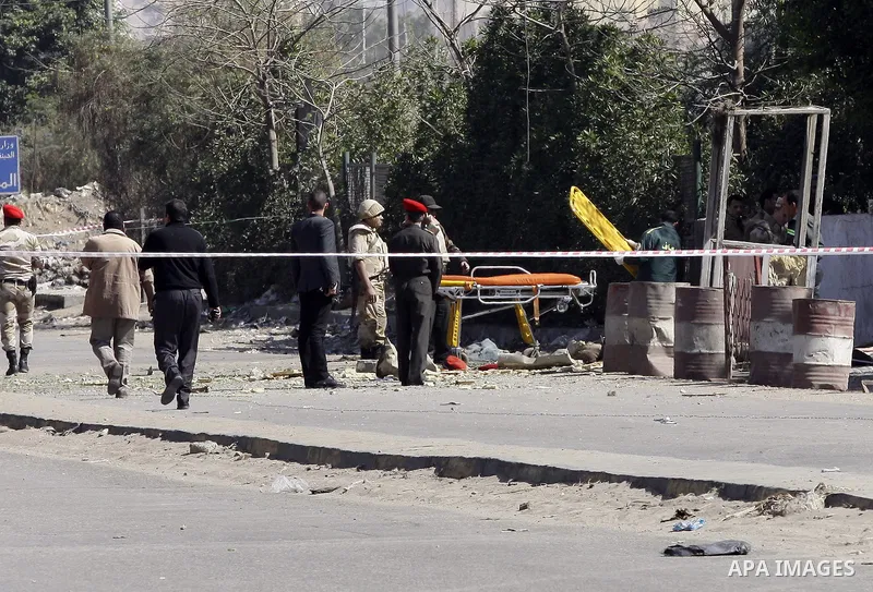 Egyptian soldiers and officials inspect the sight where gunmen killed six soldiers at a Cairo checkpoint on March 15, 2014 in an attack the military blamed on the Muslim Brotherhood movement of deposed president Mohamed...