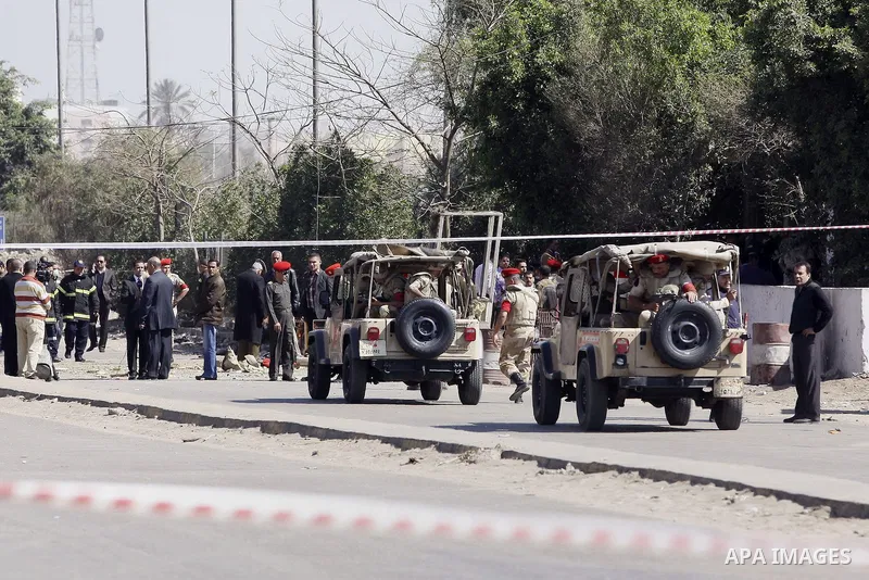 Egyptian soldiers and officials inspect the sight where gunmen killed six soldiers at a Cairo checkpoint on March 15, 2014 in an attack the military blamed on the Muslim Brotherhood movement of deposed president Mohamed...