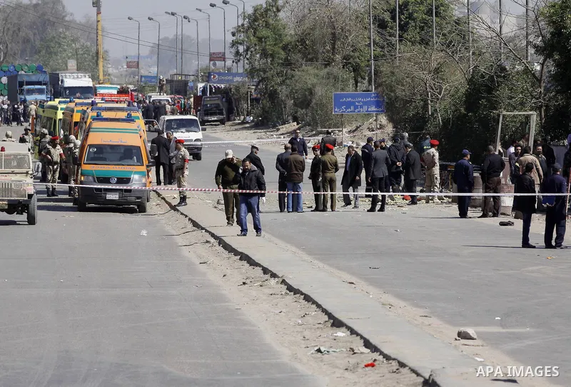 Egyptian soldiers and officials inspect the sight where gunmen killed six soldiers at a Cairo checkpoint on March 15, 2014 in an attack the military blamed on the Muslim Brotherhood movement of deposed president Mohamed...