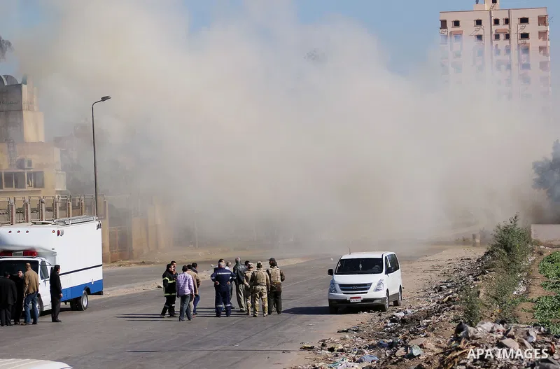 Egyptian soldiers and officials inspect the sight where gunmen killed six soldiers at a Cairo checkpoint on March 15, 2014 in an attack the military blamed on the Muslim Brotherhood movement of deposed president Mohamed...