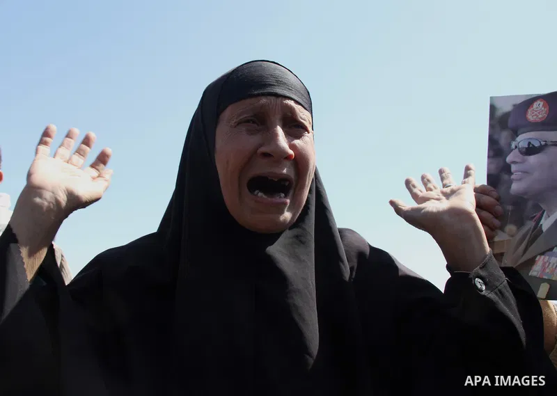 Egyptian relatives of gunmen soldiers take part a protest at the checkpoint where an attack happened in the Shubra Al-Kheima neighborhood, the outskirt of northern Cairo, Egypt, on March 15, 2014. At least six Egyptian s...