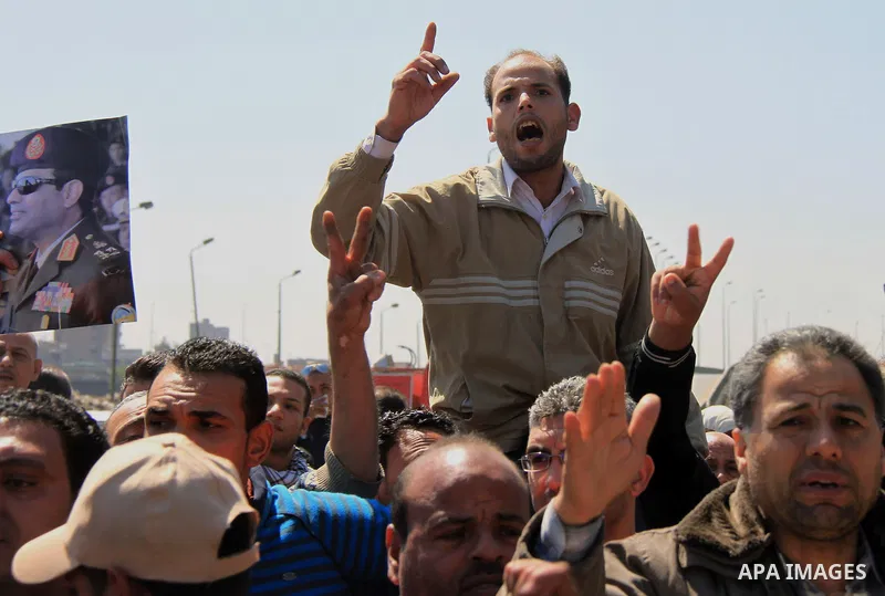 Egyptian relatives of gunmen soldiers take part a protest at the checkpoint where an attack happened in the Shubra Al-Kheima neighborhood, the outskirt of northern Cairo, Egypt, on March 15, 2014. At least six Egyptian s...