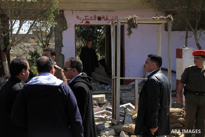 Egyptian soldiers and officials inspect the sight where gunmen killed six soldiers at a Cairo checkpoint on March 15, 2014 in an attack the military blamed on the Muslim Brotherhood movement of deposed president Mohamed...