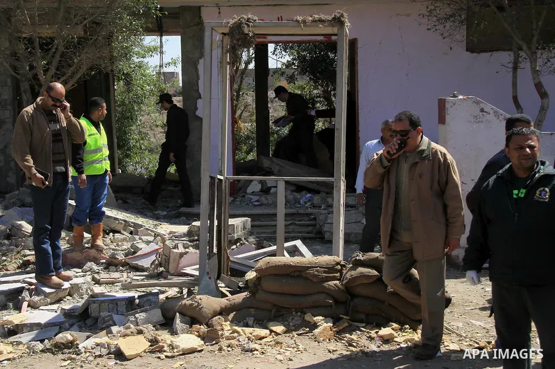 Egyptian soldiers and officials inspect the sight where gunmen killed six soldiers at a Cairo checkpoint on March 15, 2014 in an attack the military blamed on the Muslim Brotherhood movement of deposed president Mohamed...