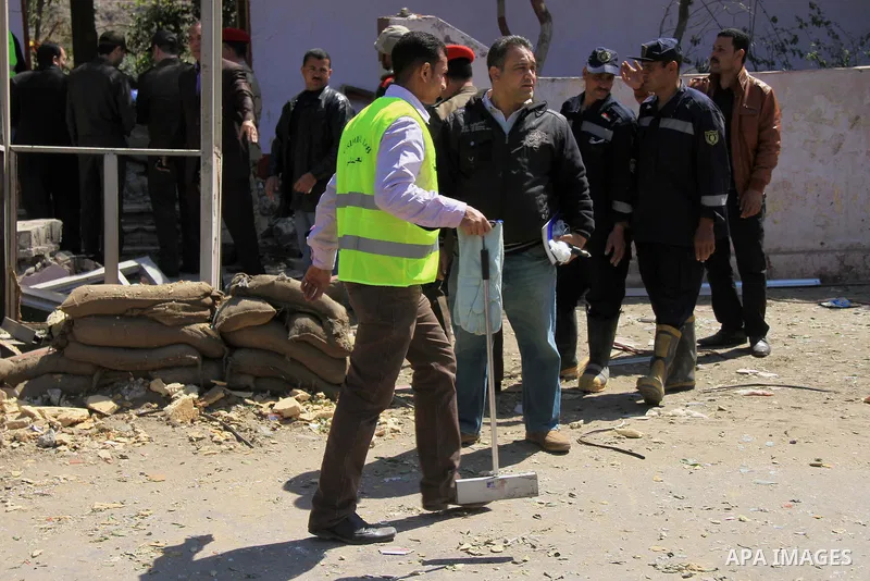 Egyptian soldiers and officials inspect the sight where gunmen killed six soldiers at a Cairo checkpoint on March 15, 2014 in an attack the military blamed on the Muslim Brotherhood movement of deposed president Mohamed...