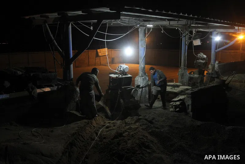 Palestinian construction workers work at night in Gaza city, on March 15, 2014. The Gaza Strip's sole power station stopped generating electricity on Saturday, causing blackouts throughout the territory after it ran out...
