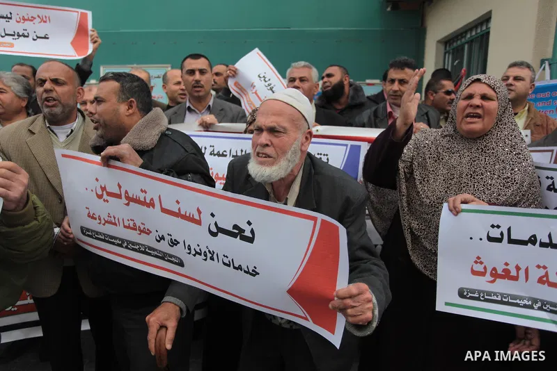 Palestinians take part in a protest against the decision made by the United Nations Relief and Works Agency (UNRWA) to reduce food aid delivered to the Gaza Strip in front of the UNRWA headquarters in Gaza City on March...