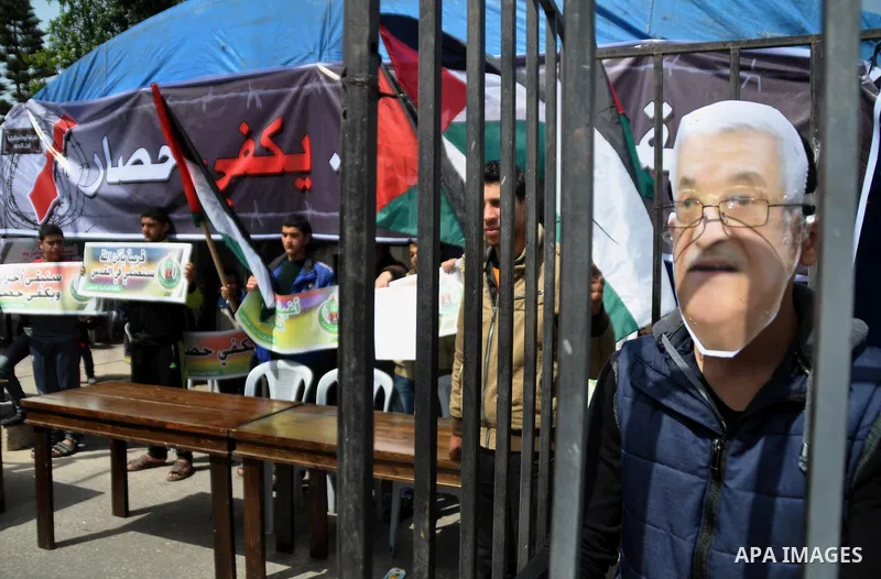 A protester wearing a mask depicting Palestinian President Mahmoud Abbas during a protest against the Egyptian-Israeli blockade on Gaza Strip, in Gaza City on March 16, 2014. Photo by Mohammed Talatene